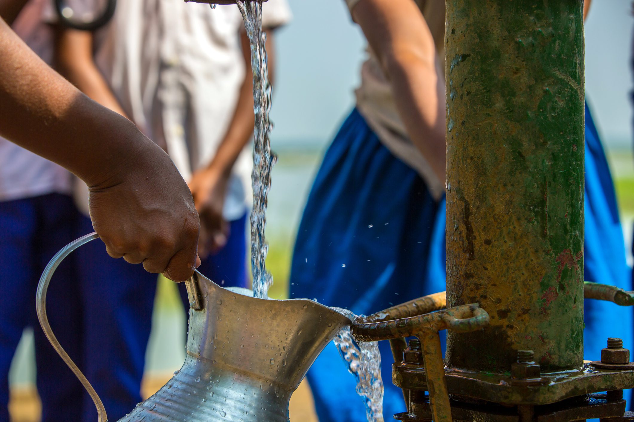 Hand filling jug from water pump